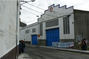 Unha faixa pendurada na f&aacute;brica na que se pode ler "Conservas P&eacute;rez Lafuente, as fixas descontinuas queremos traballar xa! CIG"